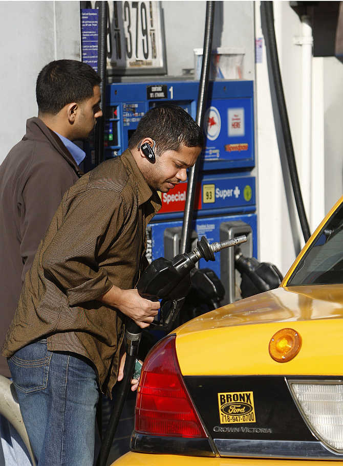 A taxi driver fills his cab at a petrol pump on Manhattan's West Side in New York.