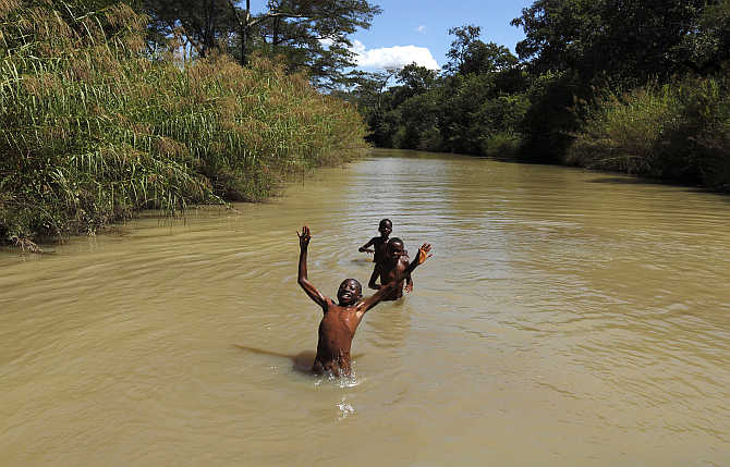Children swim in a river close to the town of Chikuni in the south of Zambia.