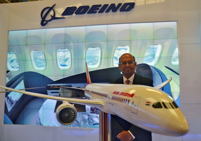 Dinesh Keskar, Boeing's vice-president for sales in Asia Pacific and India, poses with a model of 787 Dreamliner during 'Aero India 2013' on the outskirts of Bengaluru.