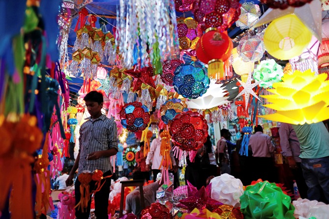 A vendor stands under lanterns for sale at a Diwali market in Mumbai. 