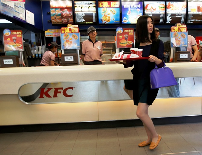 A woman holds food inside a KFC restaurant in Beijing.