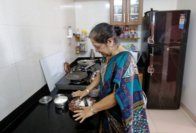 Rekha Chitre, 63, cooks in the kitchen of her flat at the Athashri retirement village in Baner, on the outskirts of Pune.