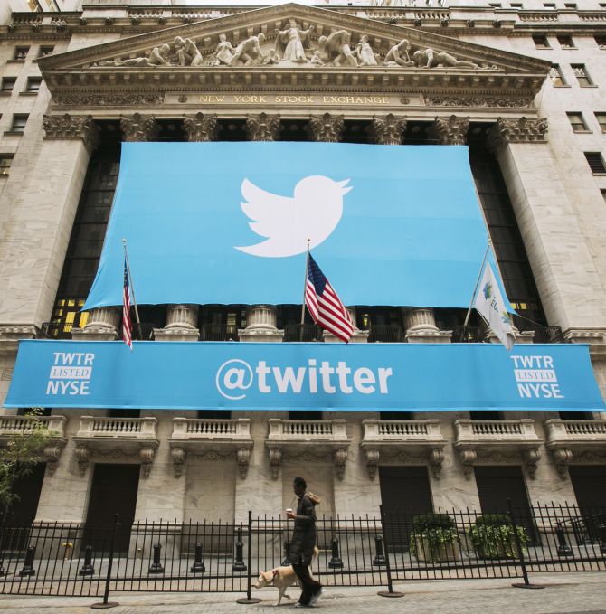 A sign displays the Twitter logo on the front of the New York Stock Exchange.
