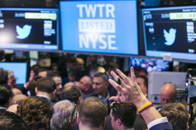 A trader raises his hand just before the Twitter Inc. IPO begins on the floor of the New York Stock Exchange.