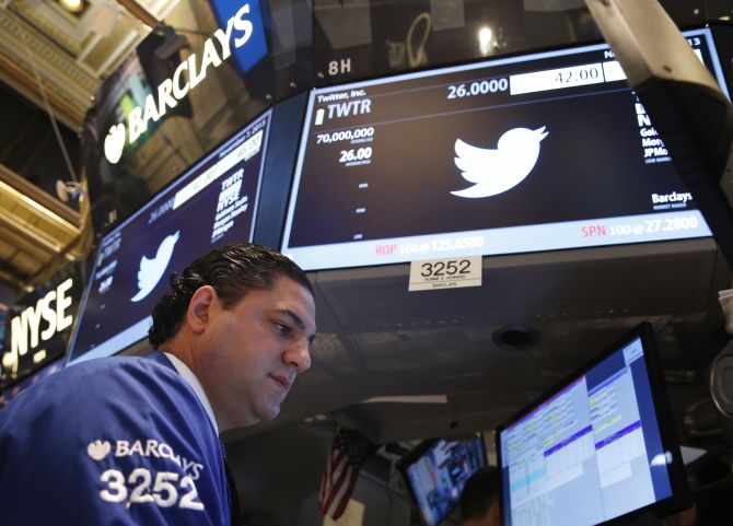 A trader looks over his screens before the start of the Twitter Inc. IPO on the floor of the New York Stock Exchange.