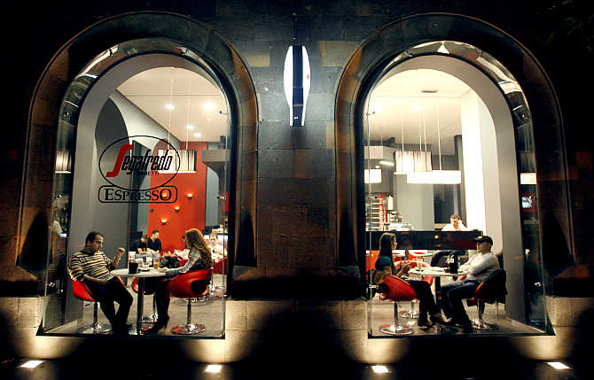 People sit in a cafe along a street in Yerevan, Armenia.