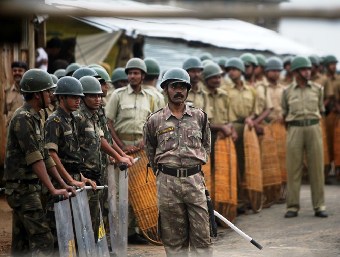 A file photograph shows riot policemen standing guard inside the main entrance of the Tata car plant in Singur.