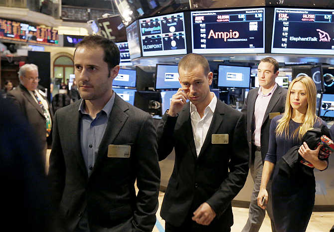 Twitter co-founders Evan Williams, left, and Jack Dorsey, centre, walk together during the Twitter's IPO on the floor of the New York Stock Exchange.