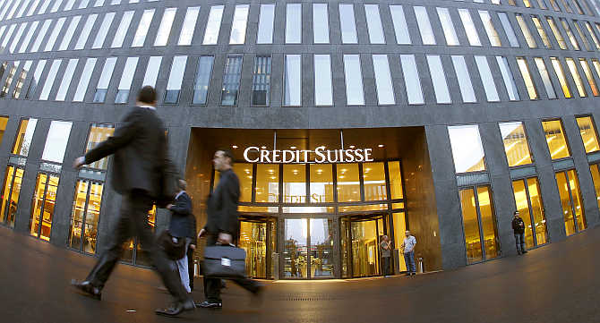 People walk past an office building of Swiss bank Credit Suisse in Zurich.