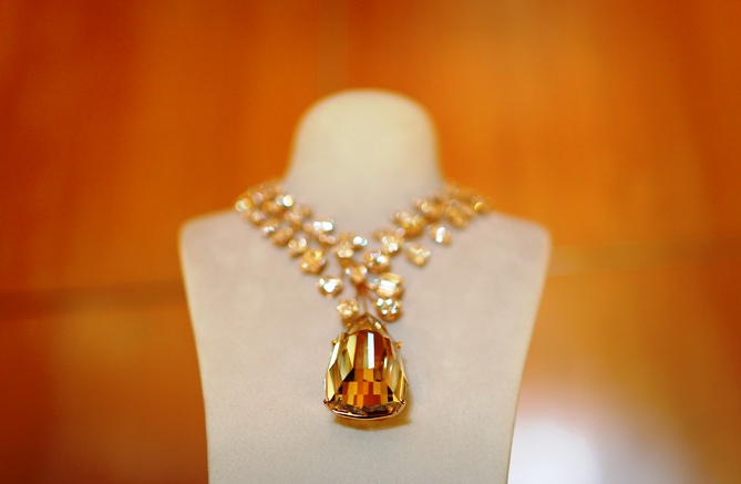 A rose gold necklace with a 407 carat yellow diamond is presented on a stand during a media event in Singapore.