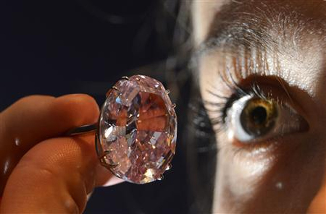 Model Annabeth Murphy-Thomas poses with The Pink Star diamond at Sotheby's auction.