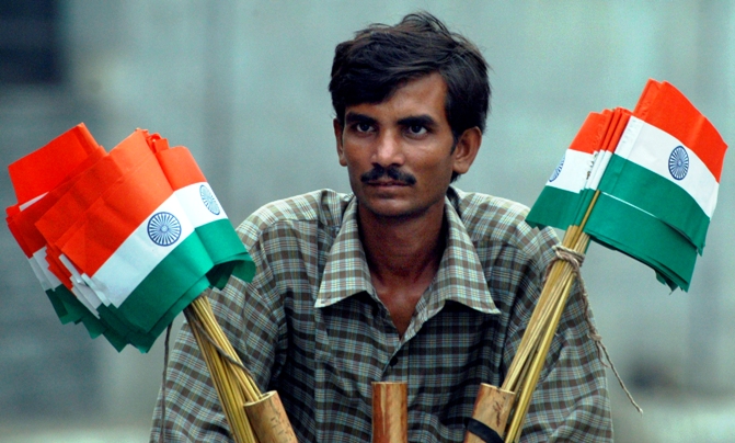 A hawker sells national flags on the eve of Independence Day in New Delhi.