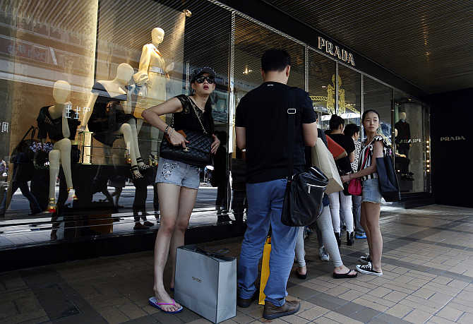 Customers line up outside a Prada store at Hong Kong's shopping district.