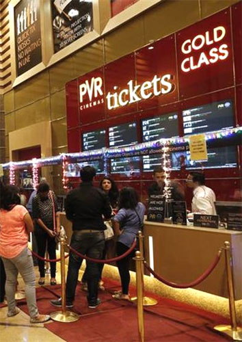 Cinema-goers wait to collect their tickets at a PVR Multiplex in Mumbai.