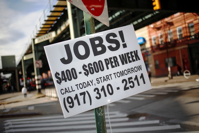 A sign advertising jobs is posted along a street in the Brooklyn borough of New York October 23, 2013.