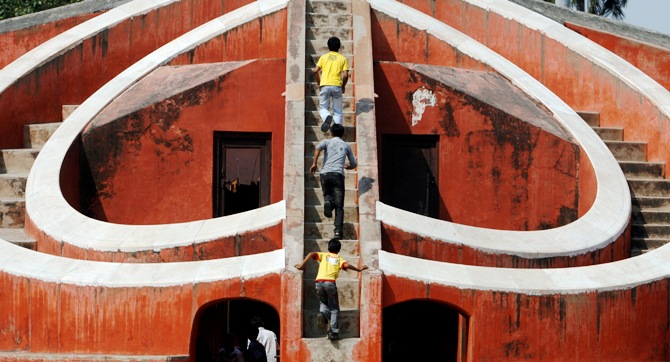 Children play inside one of the instruments of Jantar Mantar, a collection of architectural astronomical instruments, in New Delhi.