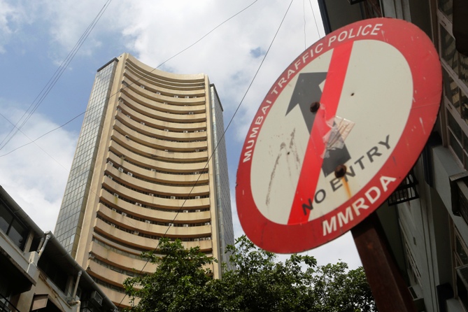A road sign is seen next to Bombay Stock Exchange building in Mumbai.