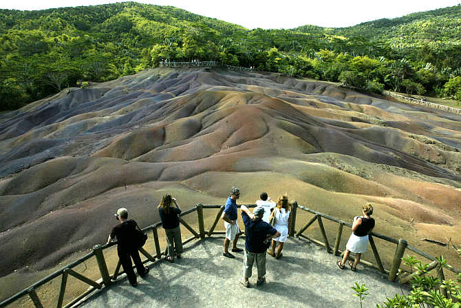 Tourists view the unusual natural phenomena of the seven-coloured earth at Chamarel in west Mauritius.