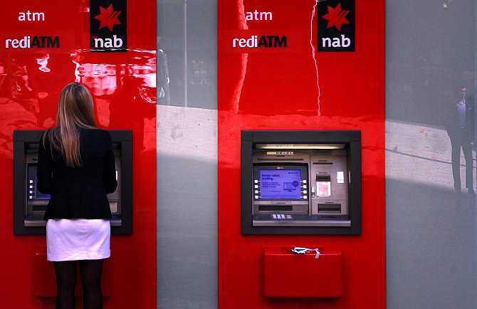 A woman uses an ATM in Sydney, Australia.