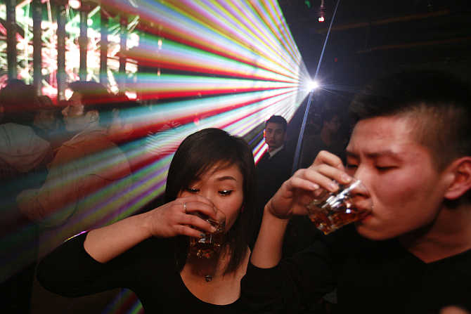 Guests drink next to the dance floor during a night out in Shanghai, China.