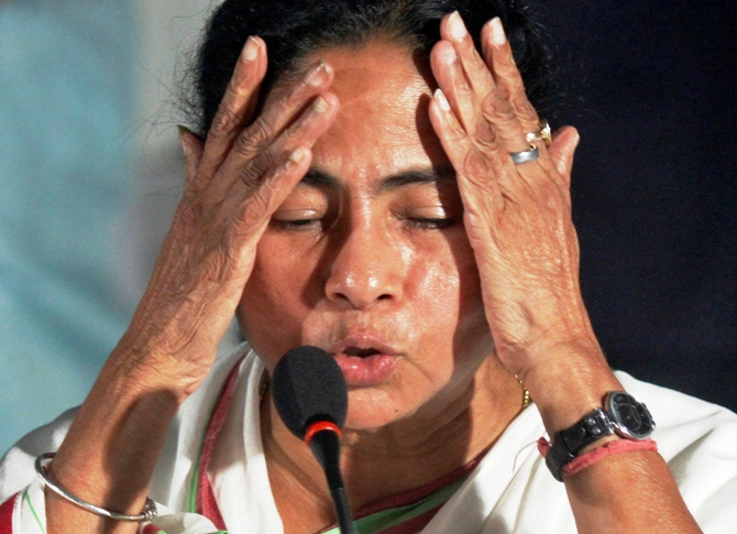 West Bengal Chief Minister Mamata Banerjee gestures during a news conference.