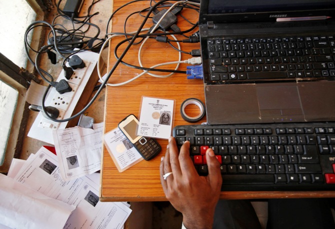 An operator works on his table while enrolling villagers for the Unique Identification (UID) database system at an enrolment centre at Merta district in Rajasthan.