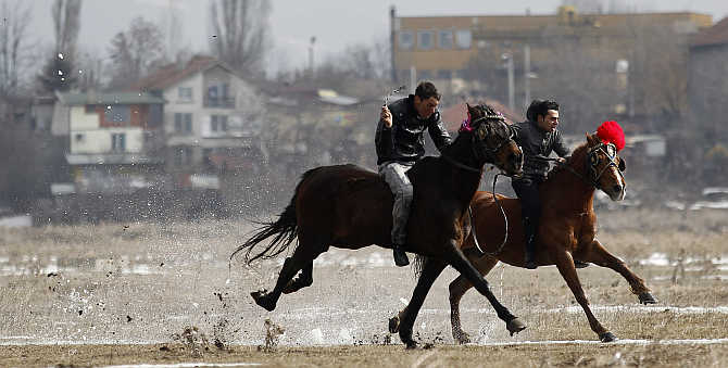 Men ride horses during celebrations marking the traditional holiday Todorov den, also known as the Horse Easter, near Sofia, Bulgaria.