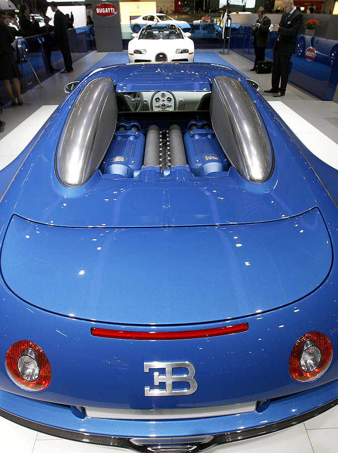 A Bugatti Bleu Centenaire, front, and a Veyron 16.4 on display at the Palexpo in Geneva, Switzerland.