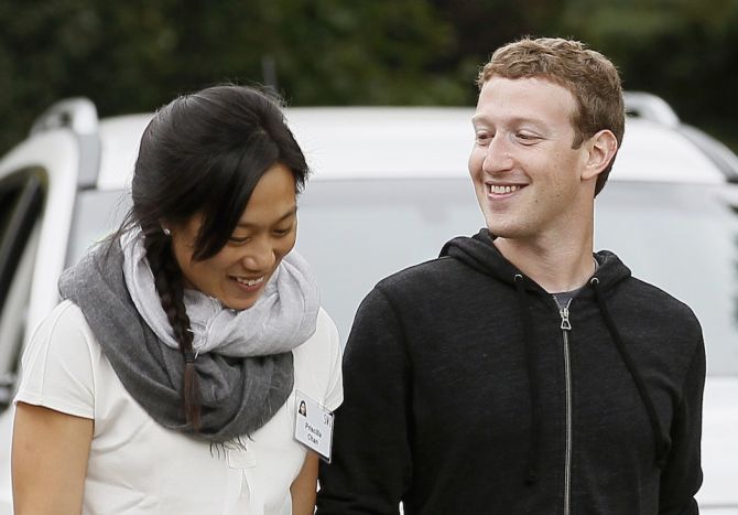 Facebook CEO Mark Zuckerberg walks with his wife Priscilla Chan at the annual Allen and Co. conference at the Sun Valley, Idaho Resort.