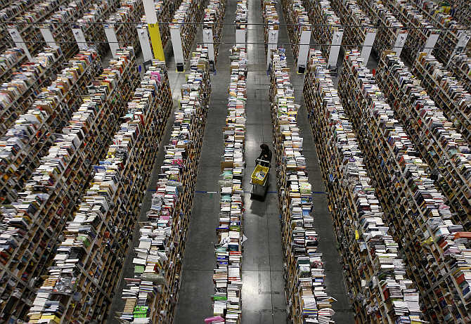 A worker gathers items for delivery from the warehouse floor at Amazon's distribution centre in Phoenix, Arizona.