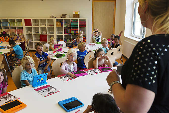 A teacher explains to her students the basics of using their iPads at the Steve Jobs school in Sneek, the Netherlands.