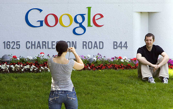 A man has his picture taken in front of Google headquarters in Mountain View, California.