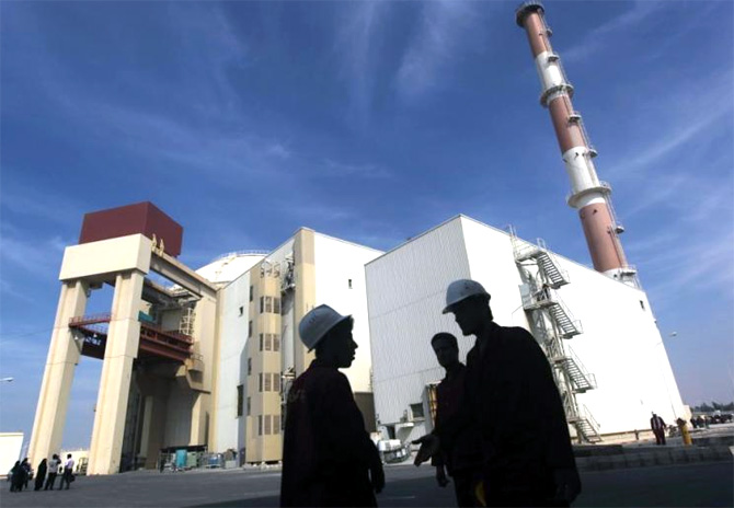 Iranian workers stand in front of the Bushehr nuclear power plant.