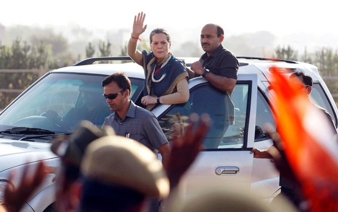 Chief of Congress party Sonia Gandhi (C) waves towards her supporters from a vehicle after she addressed a rally ahead of the state elections in Dungarpur town, Rajasthan.