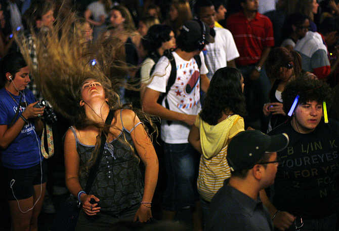 Revellers dance to music on their headphones during a Silent Rave at Union Square Park in New York City, United States.
