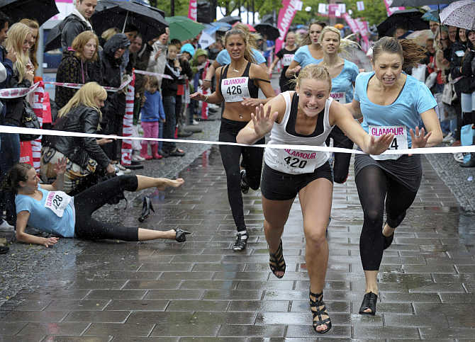 Elin Bjerre of Kristianstad crosses the finish line first to win the 100m final of the Stiletto Run in Stockholm, Sweden.