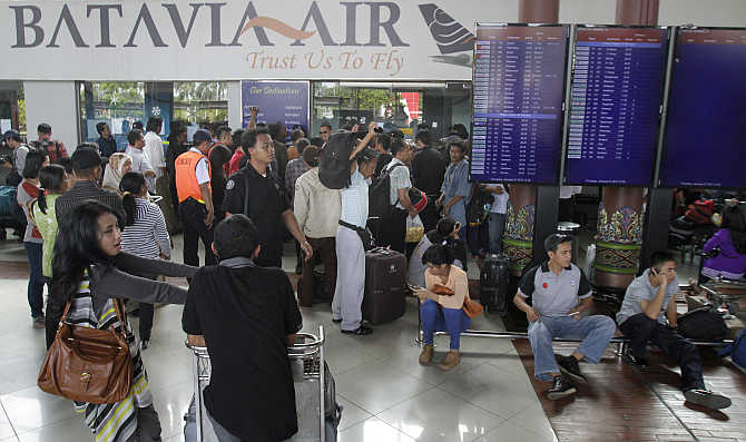 Passengers of Batavia Air gather in front of a ticket booth at the Sukarno-Hatta airport on the outskirts of Jakarta.