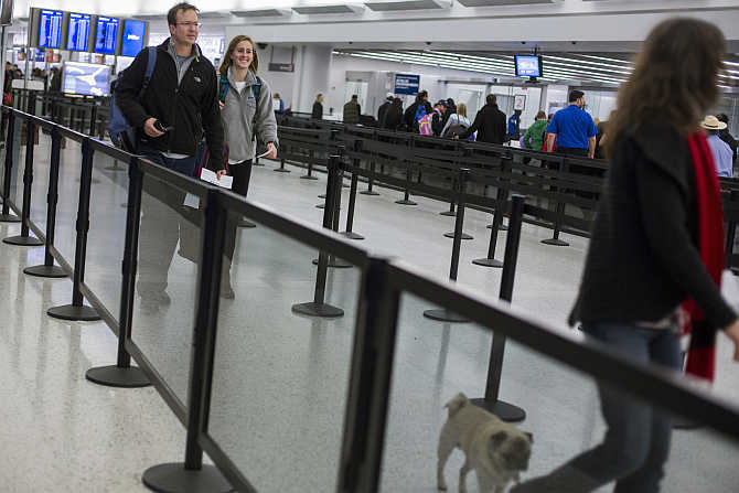 Travellers walk through a security line at John F Kennedy International Airport in New York.
