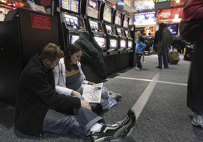 Ryan Caille and Megan Wile of Houston do crossword puzzles at McCarran International Airport in Las Vegas, Nevada.