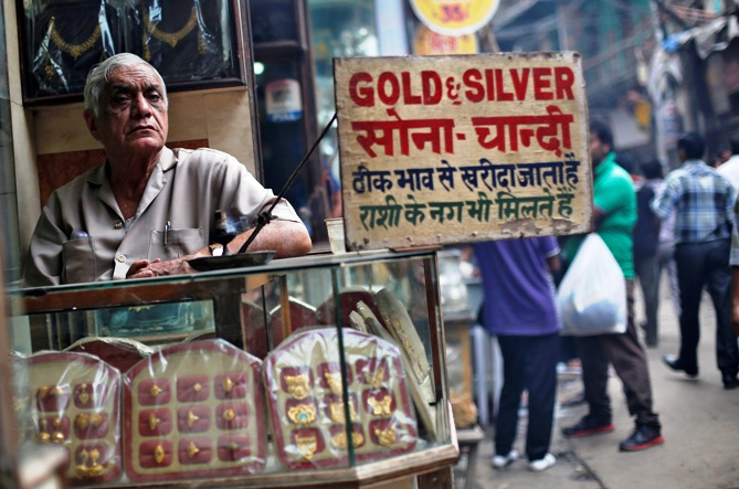 A shopkeeper waits for customers at his gold and silver jewellery shop in the old quarters of Delhi.