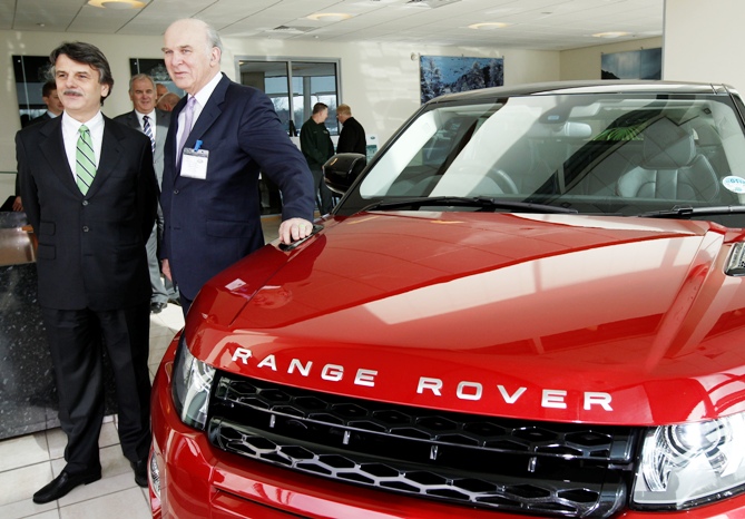 Britain's Business Secretary Vince Cable (R) looks at the new Range Rover Evoque model with company CEO Ralf Speth during a visit to Jaguar Land Rover's Halewood assembly plant, in Liverpool, northern England.