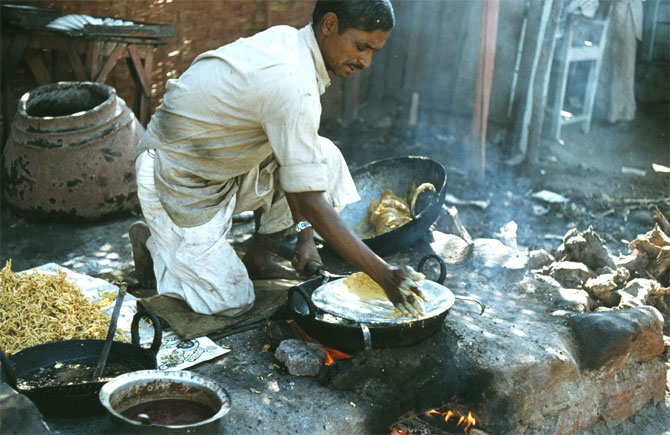 A man makes traditional morning bread.