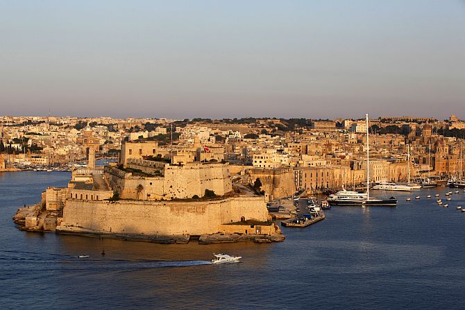 A boat sails past the medieval Fort Saint Angelo in Vittoriosa in Valletta's Grand Harbour.