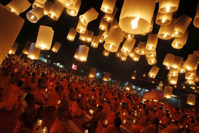Buddhist monks release paper lanterns into the sky in Suphan Buri province.