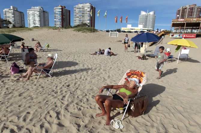 People sunbathe at the beach of the luxurious seaside resort of Punta del Este.