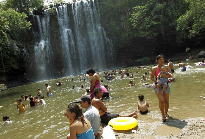 People take a bath in the Llanos del Cortes waterfall Bagaces, Guanacaste city.