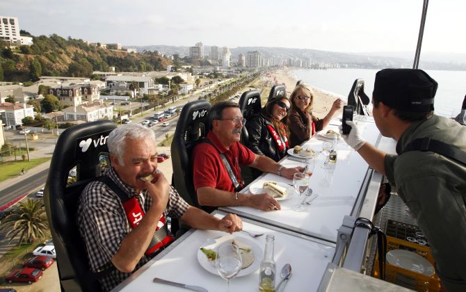 Guests have dinner at a event known as Dinner in the Sky as they are seated around a table that is lifted by a crane in Vina del Mar city, about 75 miles (120 km) northwest of Santiago.