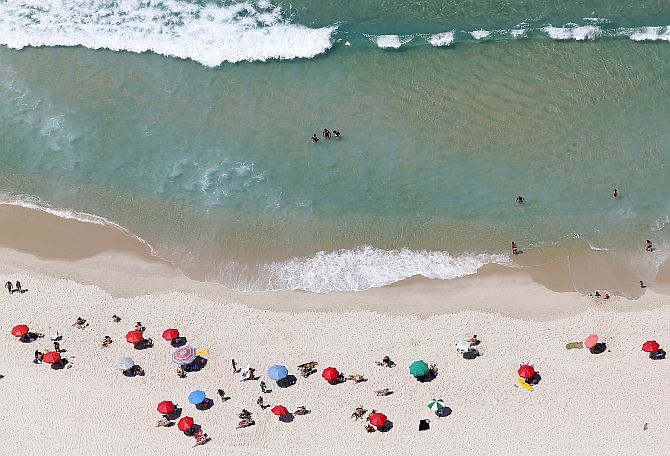 People enjoy the Barra da Tijuca beach in Rio de Janeiro.