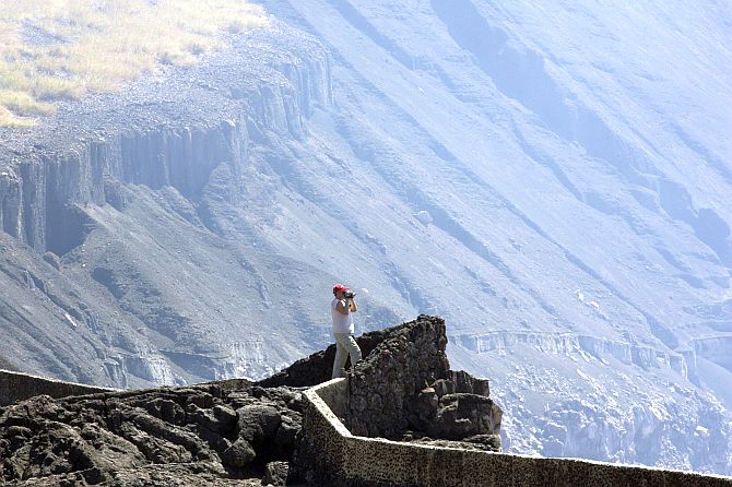 A tourist takes pictures at the Santiago Volcano National Park also known as Masaya Volcano.