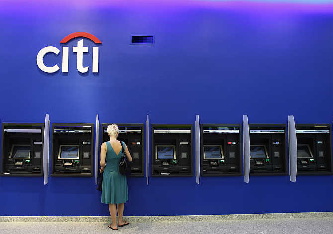 A woman uses an ATM inside a Citi bank branch in New York City.